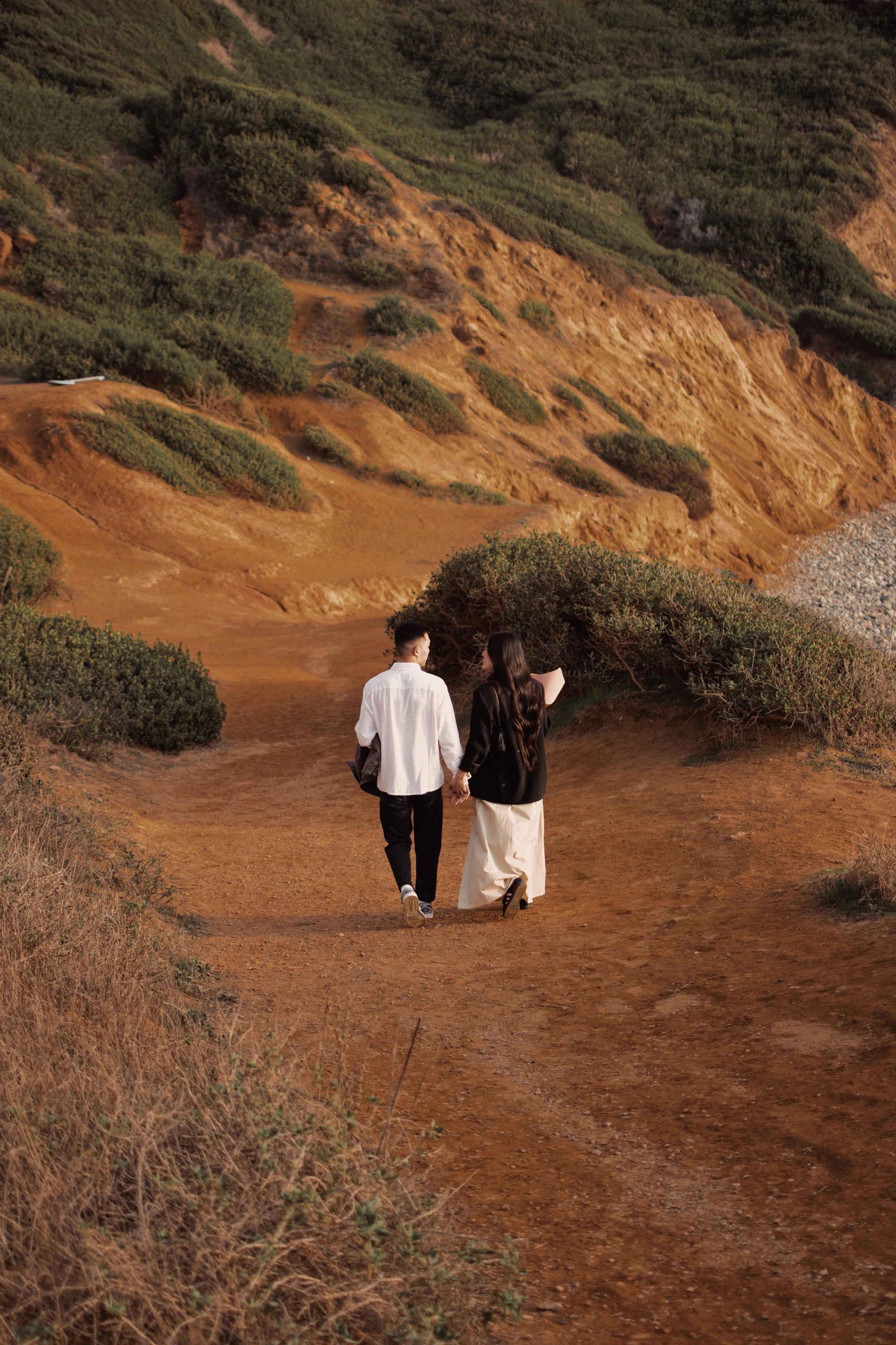 Couple walking in golden hills